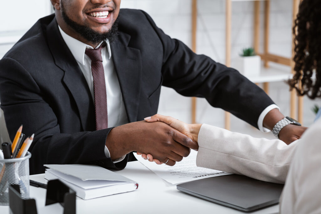 Unrecognizable African American Hiring Manager Shaking Hand Of Vacancy Candidate During